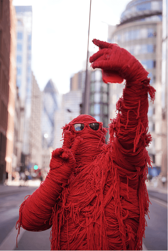Fred with arms raised in the City of London