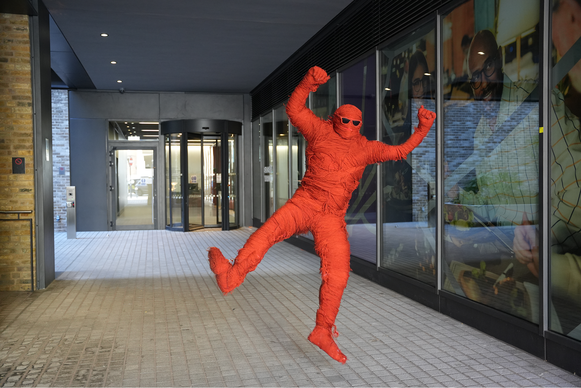 Fred, StrategiQ's mascot, leaping outside the MAD//Fest 2026 venue entrance