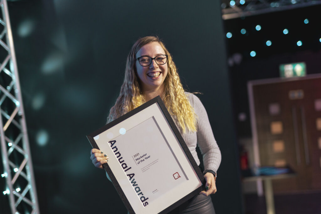 Emma holding her annual award for digital marketer of the year 2021