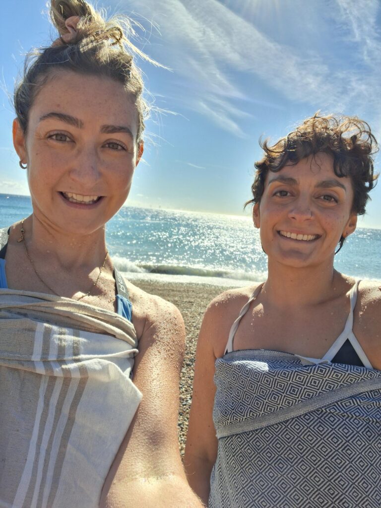 Ashleigh and Emily after a swim with the sea behind them at BrightonSEO