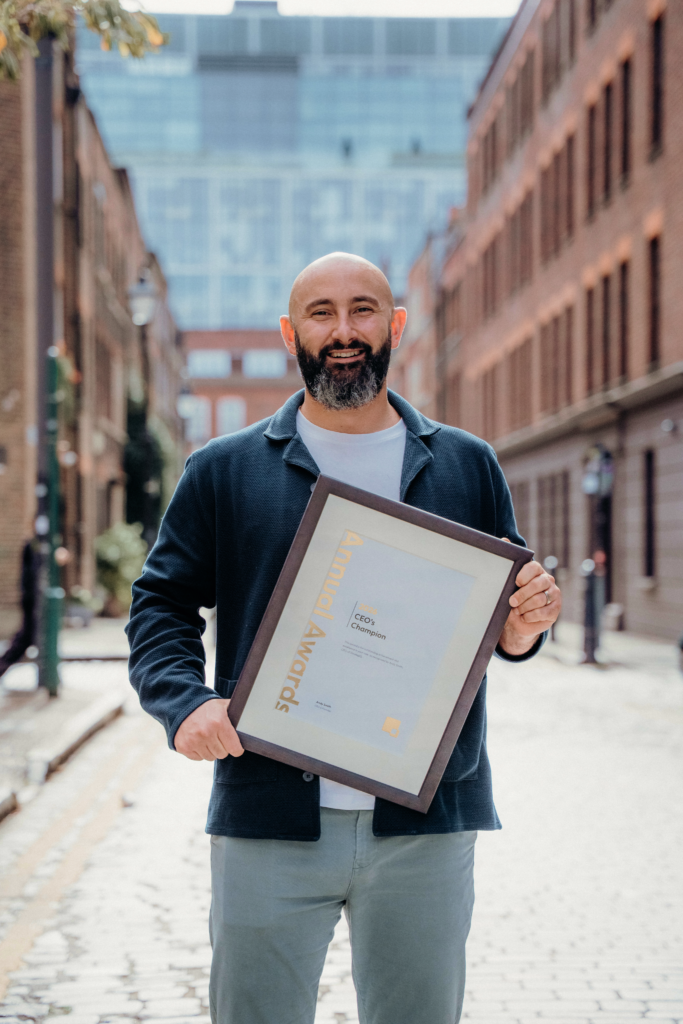 Tyler Webb-Harding holding his award certificate on a London Street