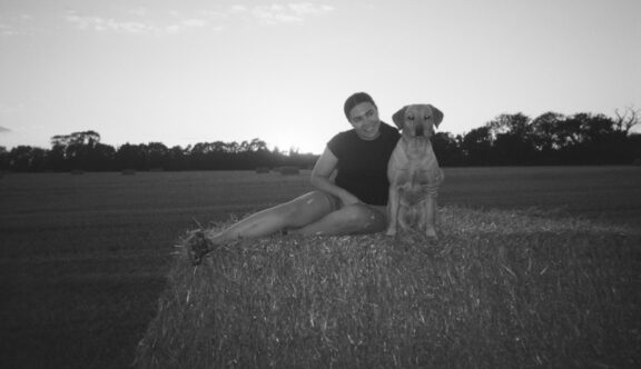 Lucy Taylor, MVP with a dog on a hay bale