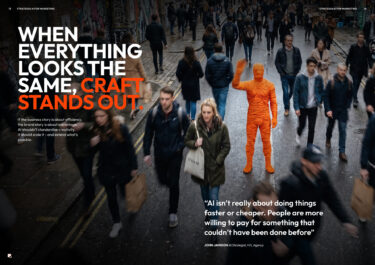Fred, a man covered in red thread stands in the middle of a crowd